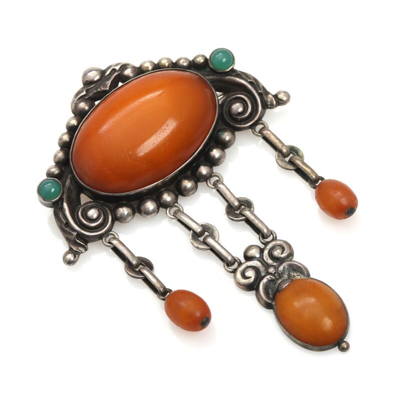 N.C. Nielsen: A Danish brooch set with cabochon-cut amber and chrysoprase, mounted in silver.